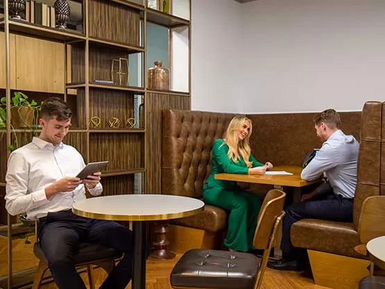Clients at Servcorp 10 Avenue Kléber enjoying a stylish coworking space designed for networking, focus, and casual meetings.